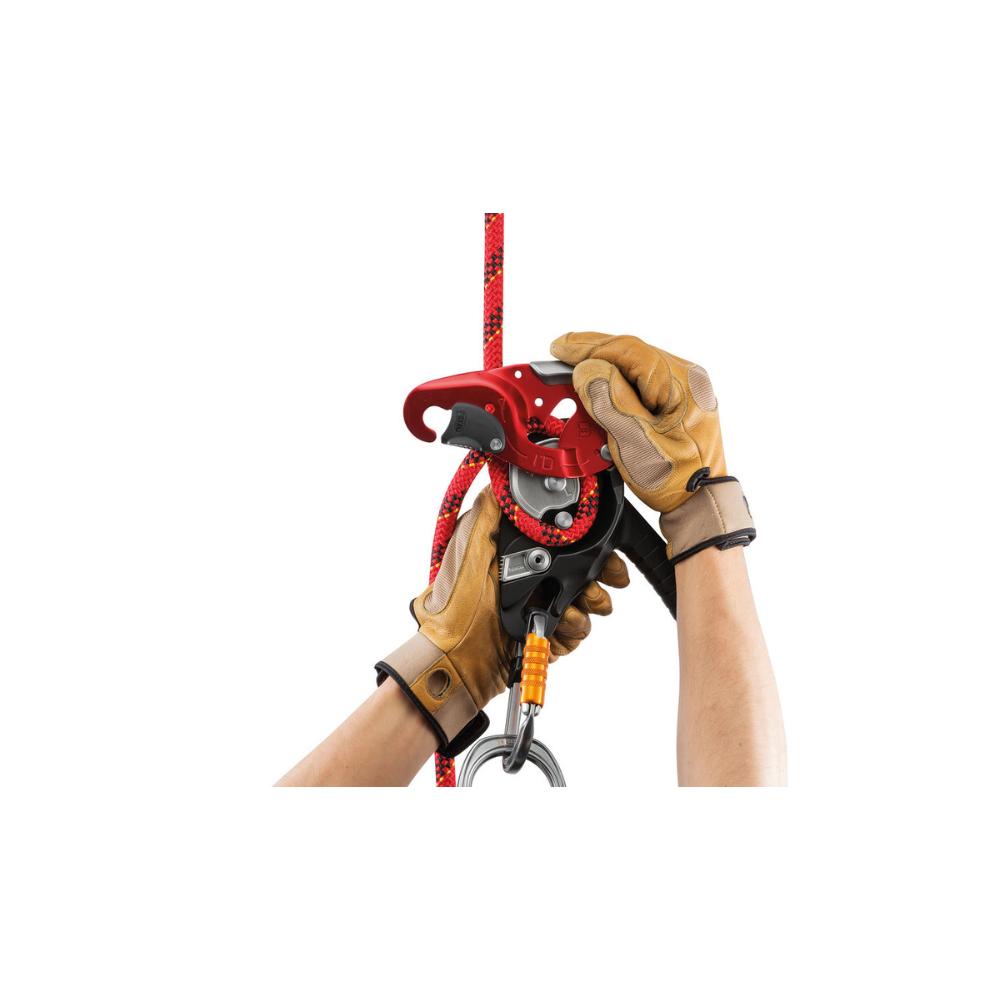The Petzl I'D L being attached to a red climbing rope