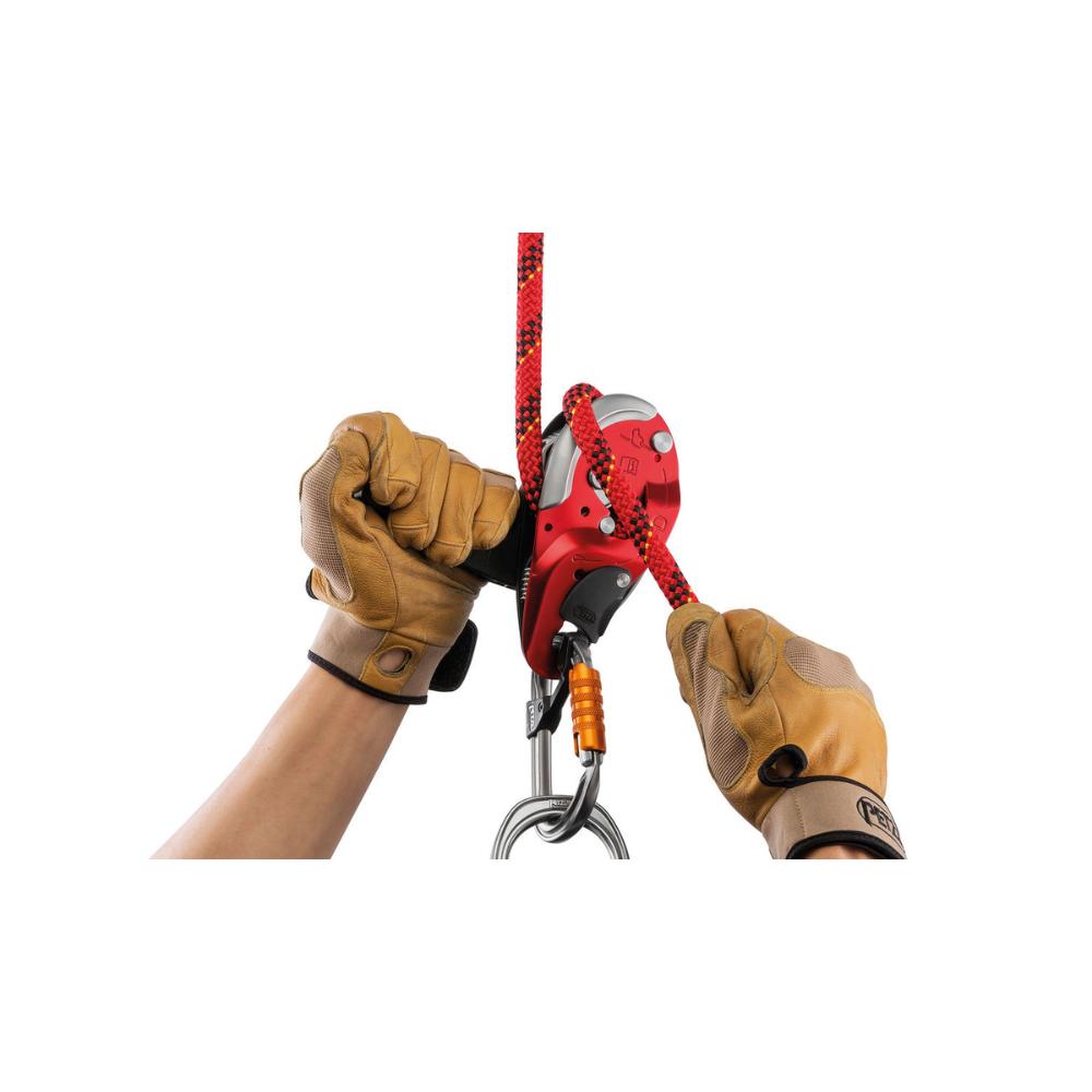 The Petzl I'D L set up for use on a red climbing rope