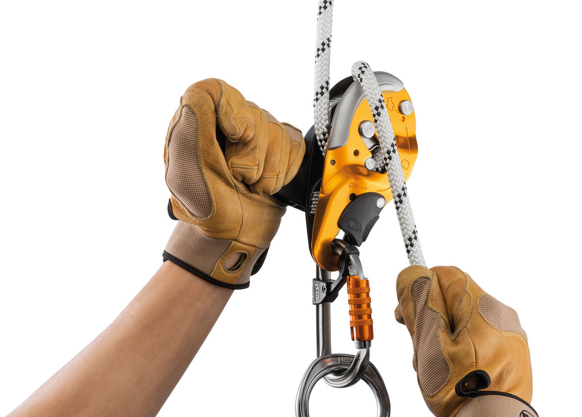 The Petzl I'D S attached to a white climbing rope