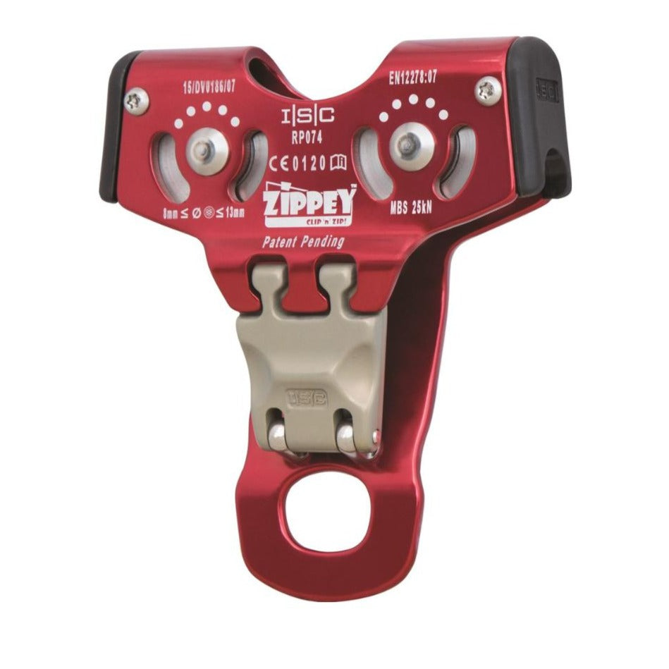 An ISC Zippey Clip 'n Zip Trolley attached to a zip line cable, with a robust red casing and dual pulleys, designed for smooth and efficient travel on zip lines in adventure parks