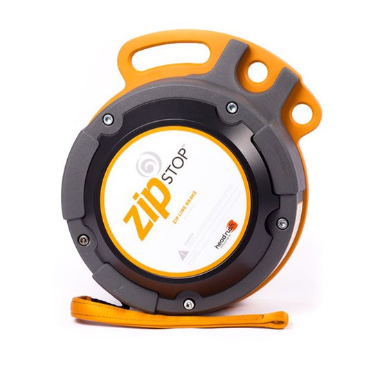 The zipSTOP Zip Line Brake with a robust black and orange casing, featuring a prominent white center label, designed to provide a smooth, consistent braking experience for zip line users.